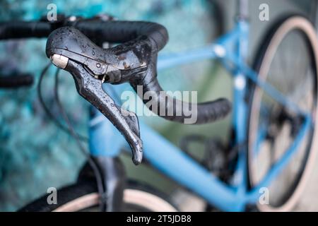 Left brake of a drop bar handlebar in a blue gravel bike Stock Photo