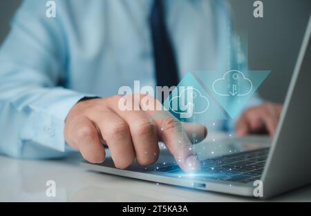 Businessman downloading business data from internet network showing usage of big data network and cloud computing system. Stock Photo