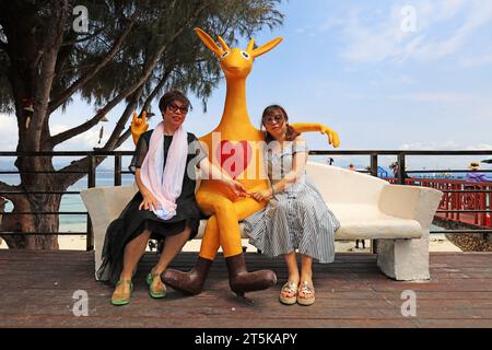 Sanya City, Hainan - March 31, 2019: Tourists rest beside kangaroo sculptures，Sanya City, Hainan Province, China Stock Photo