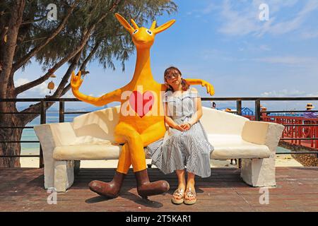 Sanya City, Hainan - March 31, 2019: Tourists rest beside kangaroo sculptures，Sanya City, Hainan Province, China Stock Photo