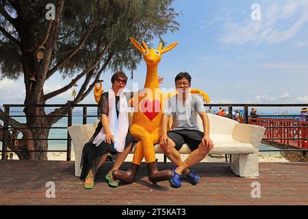 Sanya City, Hainan - March 31, 2019: Tourists rest beside kangaroo sculptures，Sanya City, Hainan Province, China Stock Photo