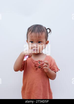 cute asian little girl brushing her teeth Stock Photo