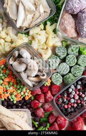 Frozen food, vegetables, fruits, meat, bread and fish on a white background. Top view Stock Photo