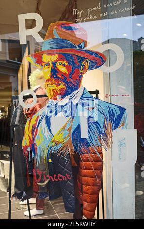 Assen, Netherlands - Oct 11 2023 Men's fashion store De Rooij in Assen has painted a portrait of Vincent Van Gogh on the store window. This is in hono Stock Photo