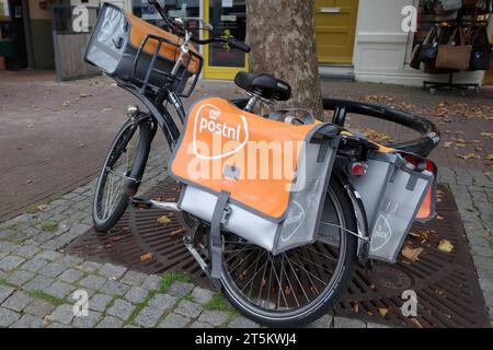 Assen, Netherlands - Oct 11 2023 Electric bike of an employee of PostNL, the largest mail delivery company in the Netherlands Stock Photo