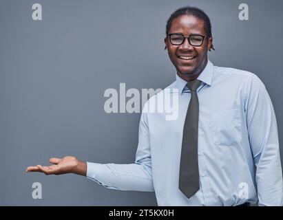 young african american man surprised showing his hand to the side Stock Photo