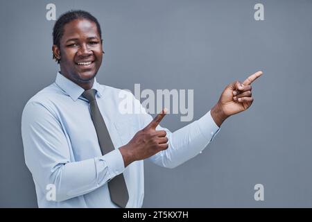 young african american man surprised showing his hand to the side Stock Photo