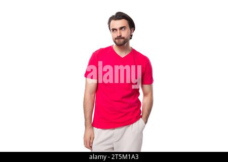 young black-haired european man dressed in red corporate t-shirt with logo print mockup Stock Photo