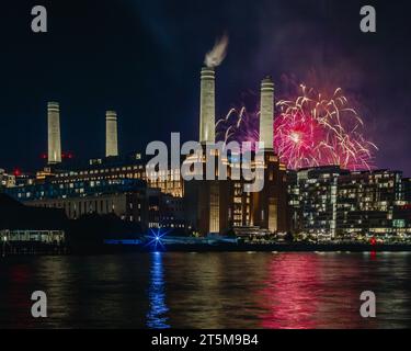 Colourful sky during Guy Fawkes night celebrations over Battersea Power station. Stock Photo