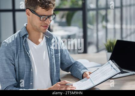 young office man at workplace making notes Stock Photo