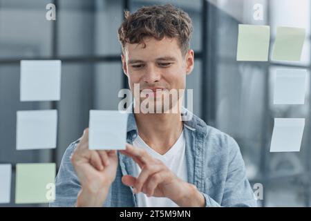 young office man at workplace making notes Stock Photo