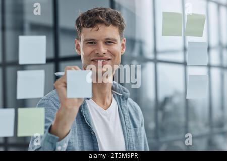 young office man at workplace making notes Stock Photo