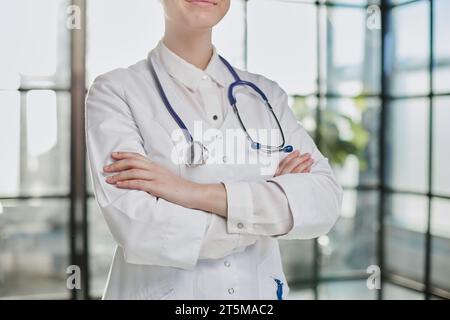 doctor with arms crossed in her consultation office with stethoscope. Stock Photo
