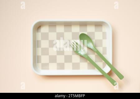 Empty tray plate and fork, spoon on pink table background. top view Stock Photo