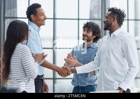Successful Business Collaboration: Executives Greet with Handshake in Office Stock Photo
