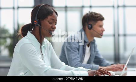 operators woman and man agent with headsets working in a call center Stock Photo