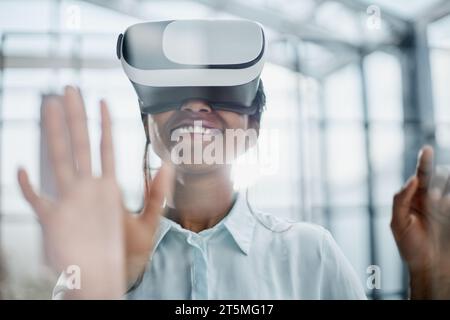 Businesswoman using vr glasses to view educational material and financial documents Stock Photo