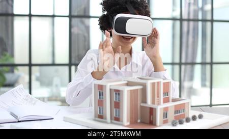 female architect designer examines house layout with 3d glasses Stock Photo