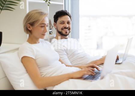 Mature people spending time at home using modern gadgets Stock Photo