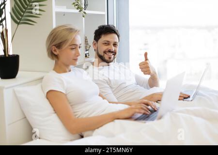 Mature people spending time at home using modern gadgets Stock Photo