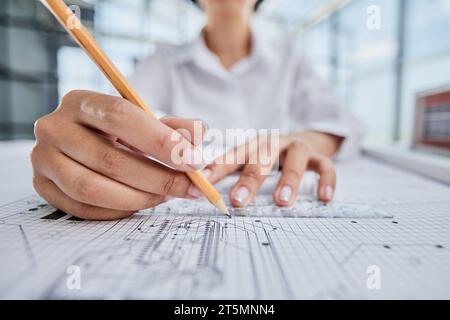 female architect designer working on blueprints Stock Photo