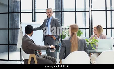 Businessman in the office writing notes on whiteboard. Stock Photo