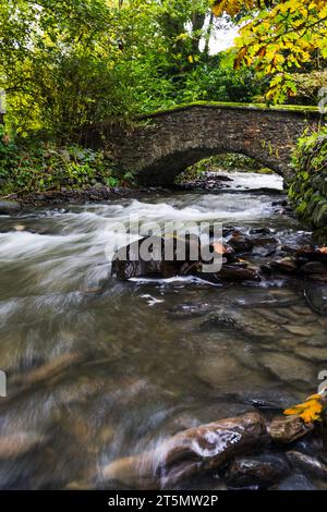 Milky water running under little stone footbridge, taken 24th Oct 2023. Stock Photo
