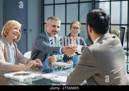 Multicultural professionals project managers group negotiating in boardroom at meeting. Stock Photo