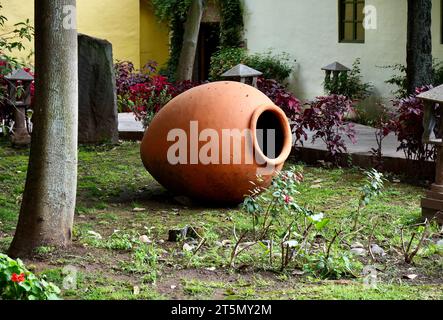 Large Terracotta Pot in a beautiful garden setting. Peru. Stock Photo