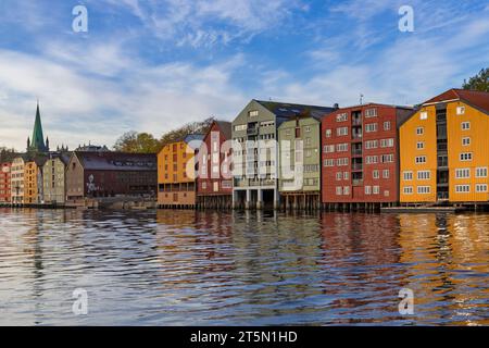 Colourful waterfront warehouses wharfs buildings of Bakklandet on stilts with reflections in river Nidelva at Trondheim, Norway, Scandinavia, Europe Stock Photo