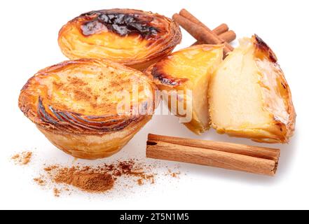 Pastel de nata tarts  and cinnamon sticks isolated on white background. Stock Photo