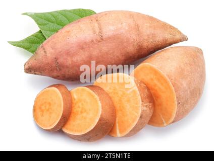 Sweet potatoes with sweet potato slices and batata leaves isolated on a white background. Stock Photo