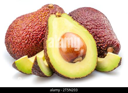 Hass avocado fruits and avocado slices isolated on white background. Stock Photo