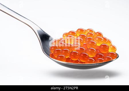 Spoon of red caviar or salmon roe isolated on white background. Clipping path. Stock Photo