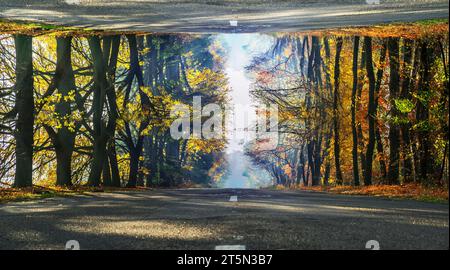 Futuristic picture of rural autumn road. The road looks like reflected in the sky. Stock Photo