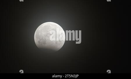 Partial lunar eclipse on October 28, 2023. The moon plunged into the shadow of the Earth. Stock Photo