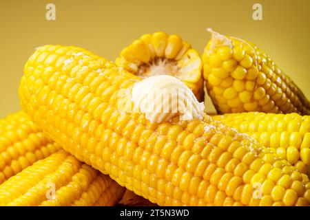 Piece of butter on a ripe boiled cob of corn. Nice food background for your projects. Stock Photo