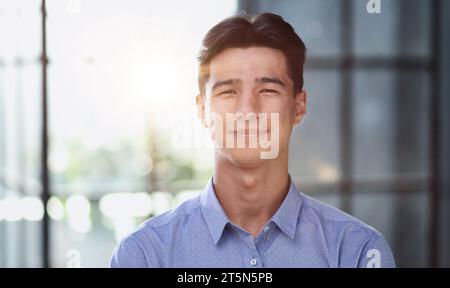 Well dressed young Asian businessman smiling confidently Stock Photo