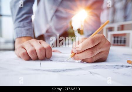 Engineer designs works according to drawings Stock Photo