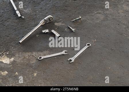 Spanners, nuts and bolts on the floor of the workshop. Stock Photo