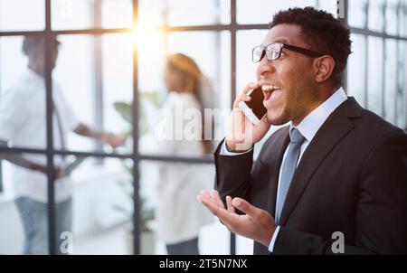 Young African American man holding his smartphone Stock Photo