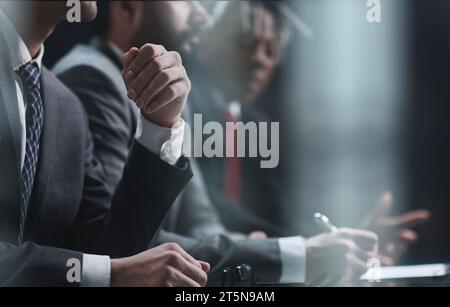 Multicultural professional businesspeople working together on research plan in boardroom. Stock Photo