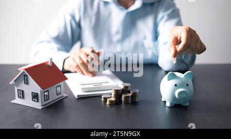 House with money. Concept of finance or refinance real estate. Symbol of house stands against background of us dollars. Property investment. Home mort Stock Photo