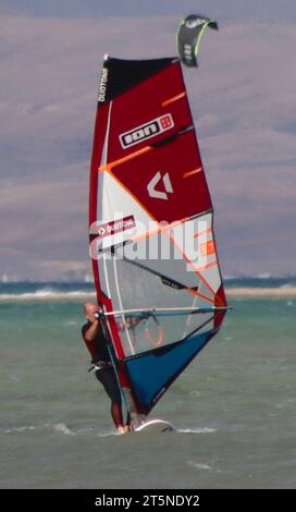 One young man windsurf off the coast of Sotavento beach in southern Fuerteventura. Stock Photo
