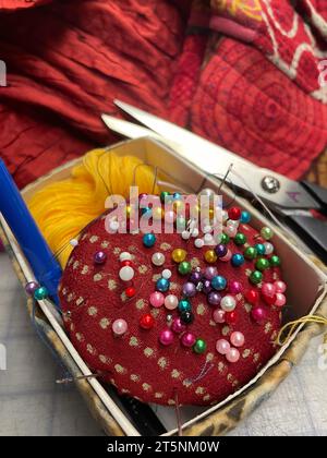 Still life of sewing notions including a pincushion and scissors Stock Photo
