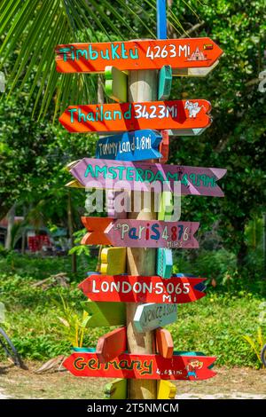 Colorful wooden travel direction signs in La Digue island, Seychelles Stock Photo