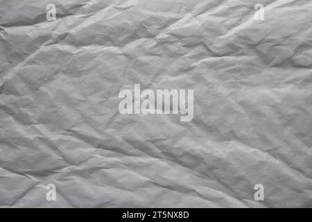 Wrinkled packing paper sheet texture. Low contrast grunge background. Stock Photo