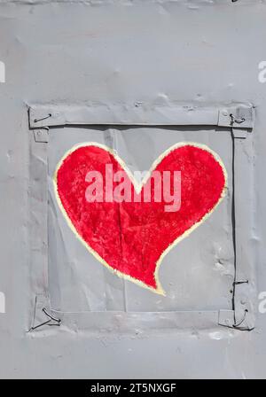 bright red heart  symbol of love and romance painted on a wall. Stock Photo