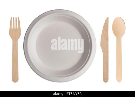 Table set with white cardboard plate with wooden cutlery next to it. Biodegradable disposable plate, fork, spoon and knife isolated on white with clip Stock Photo