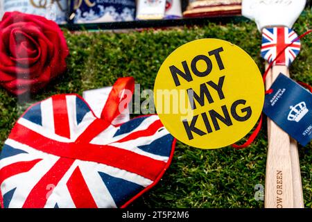 A protest sticker on a shop window where they are selling King Charles III coronation souvenirs says 'Not My King'. Cambridge, England, UK. 2023 Stock Photo